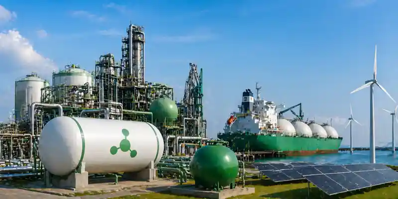 Green ammonia production plant with storage tanks, cargo ship, wind turbines and solar panels representing clean energy fuel supply and maritime bunkering