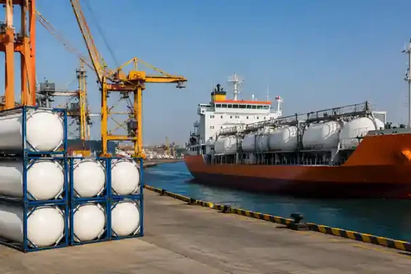 Ammonia cargo ship unloading fertilizer raw materials at industrial port terminal in India